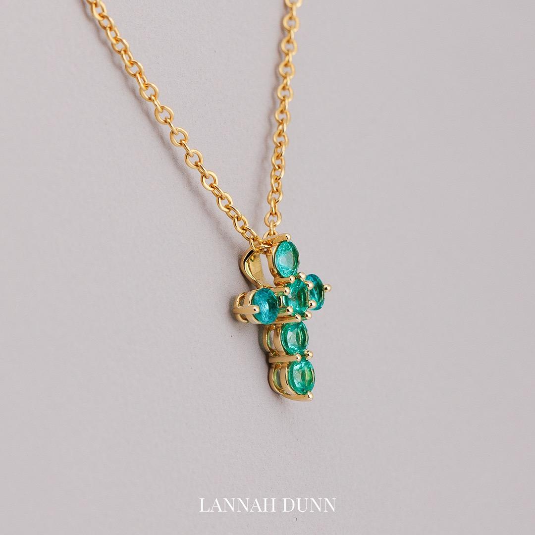 Emerald gem set cross pendant