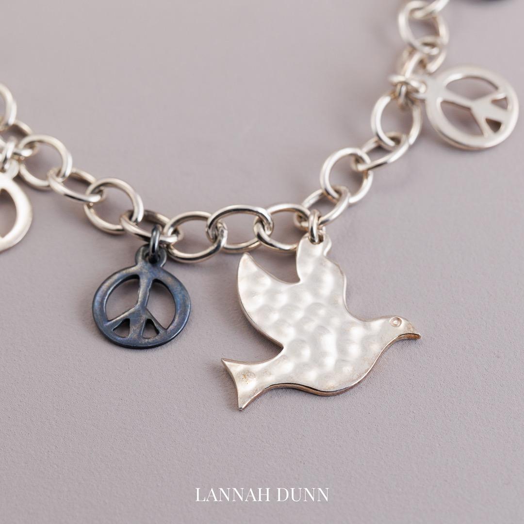 Sterling silver peace, dove, angel wing multi charm bracelet