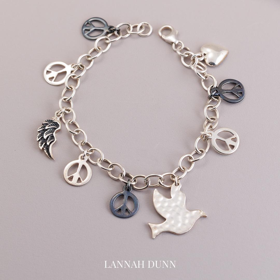Sterling silver peace, dove, angel wing multi charm bracelet