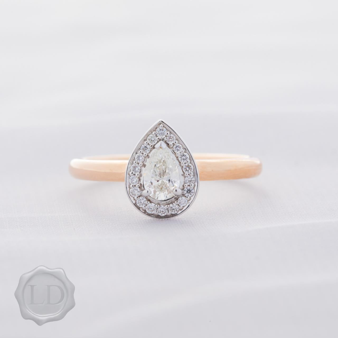 Pear cut halo engagement ring in 18ct rose white gold