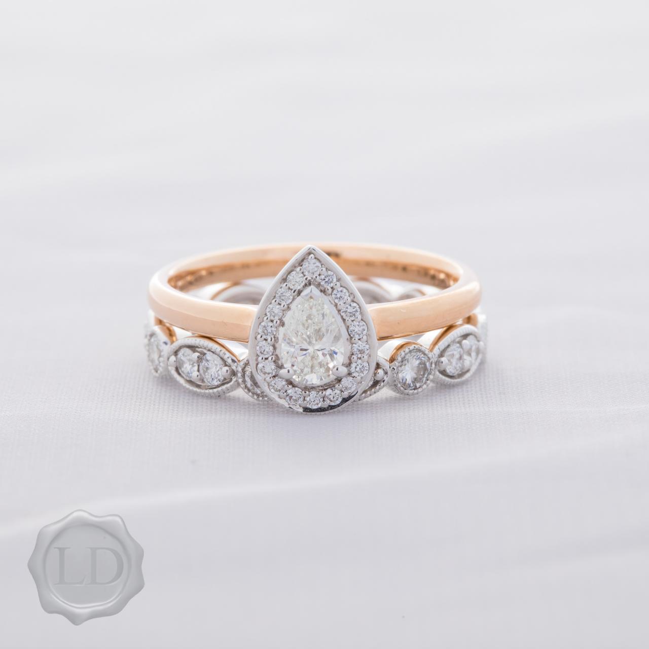 Pear cut halo engagement ring in 18ct rose & white gold
