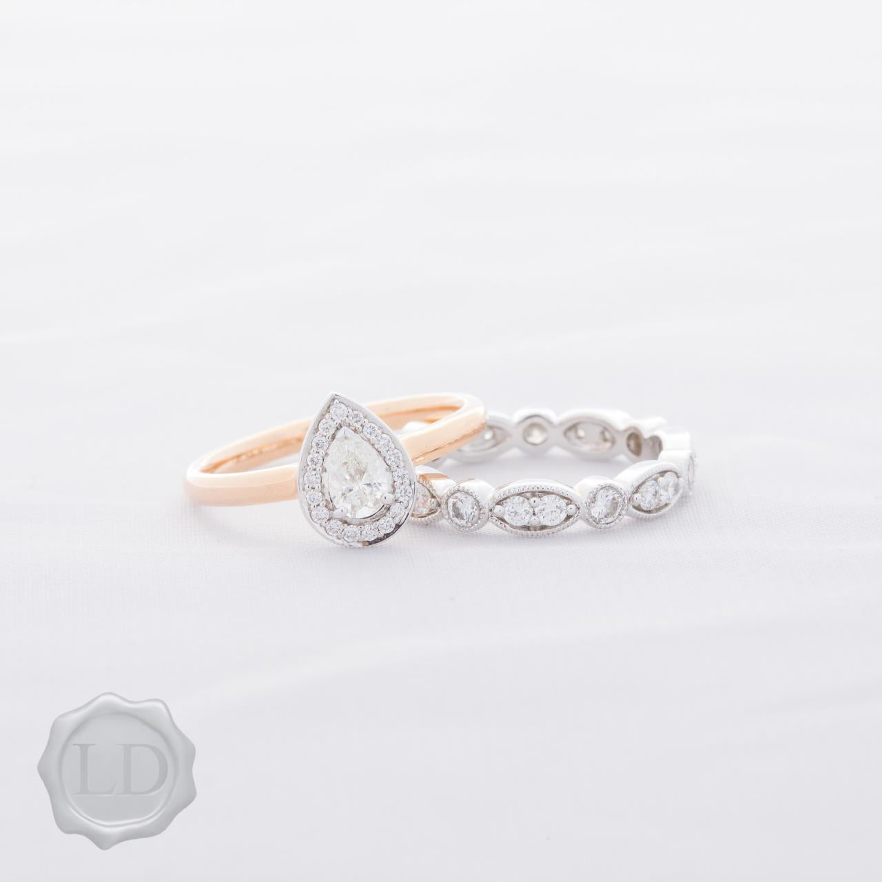 Pear cut halo engagement ring in 18ct rose & white gold