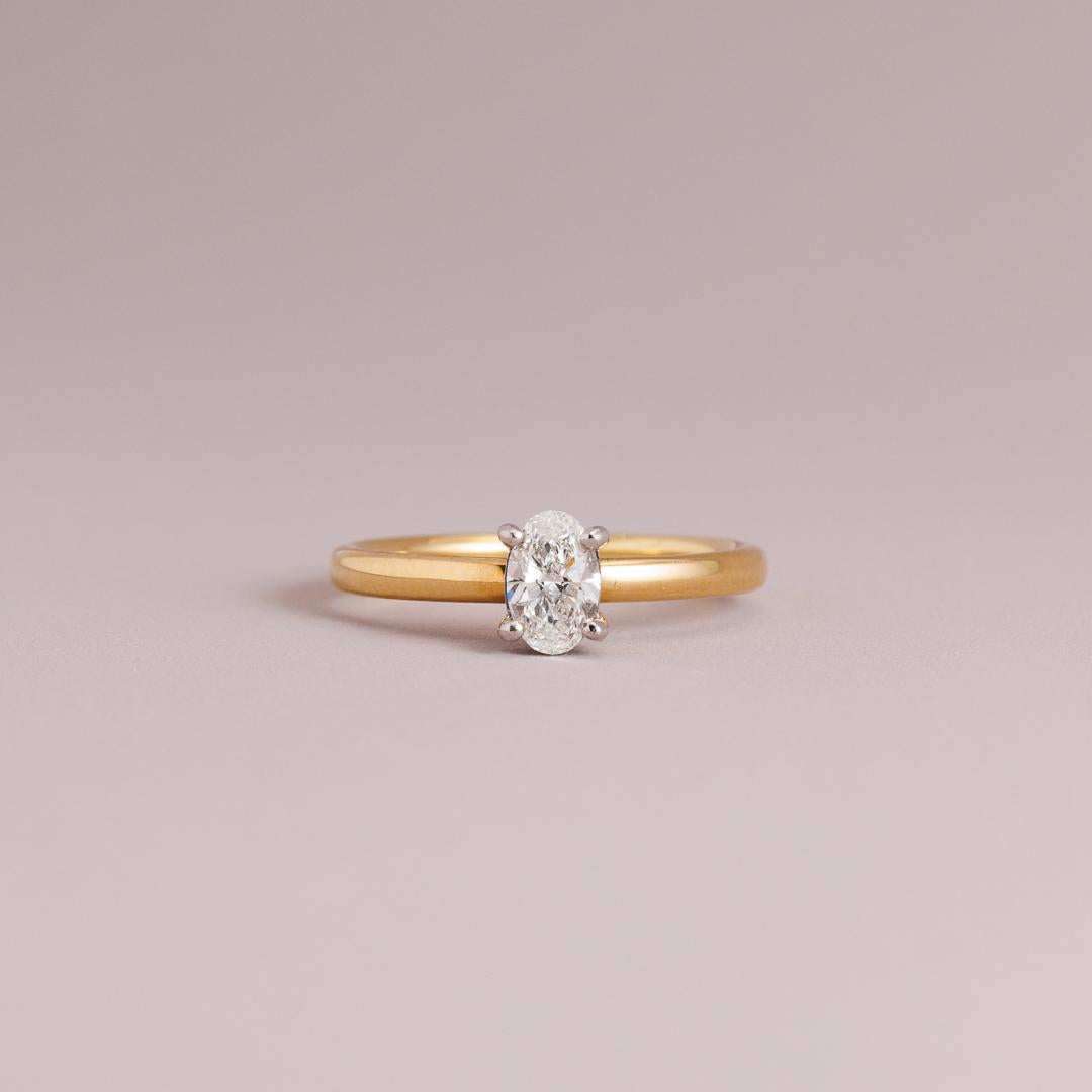 LD Oval brilliant cut diamond solitaire engagement ring, yellow gold four claw setting