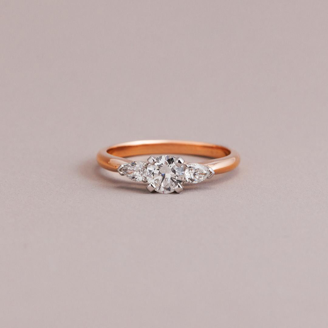 Rose gold three stone engagement ring