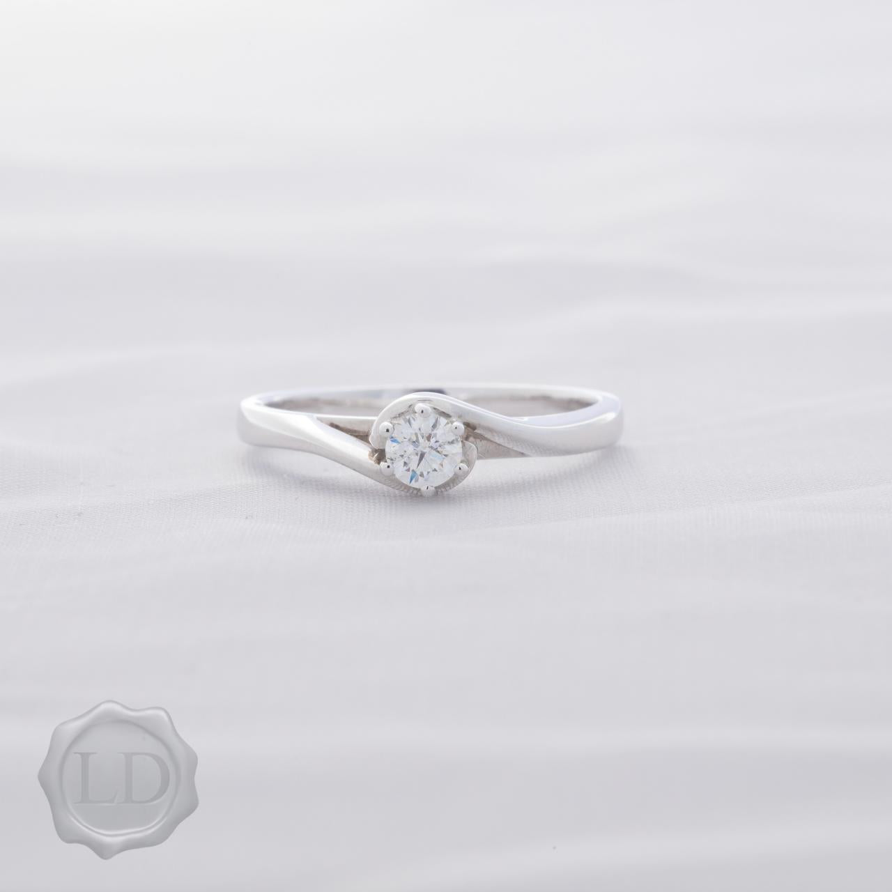 White gold round brilliant cut solitaire engagement ring with hug twist