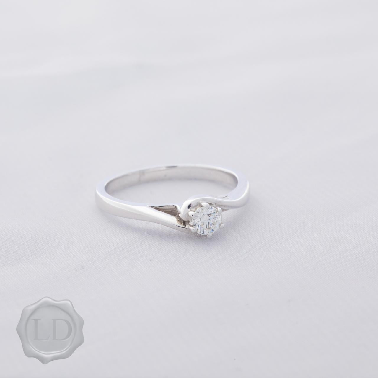 White gold round brilliant cut solitaire engagement ring with hug twist