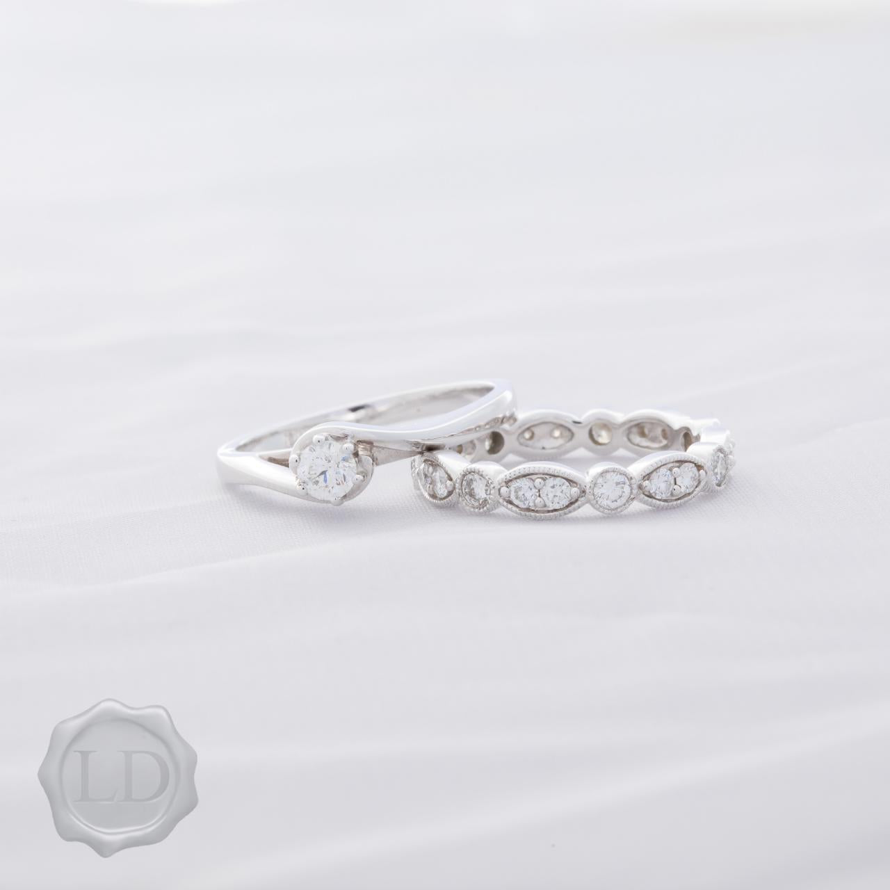 White gold round brilliant cut solitaire engagement ring with hug twist
