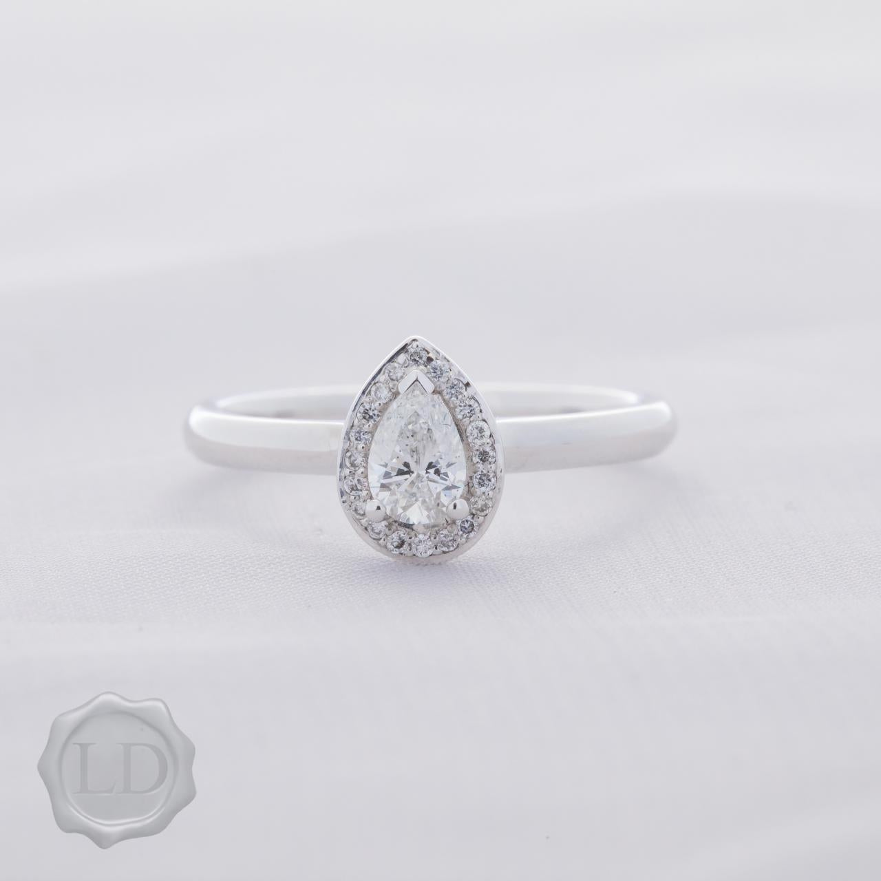 Pear cut halo engagement ring in 18ct white gold