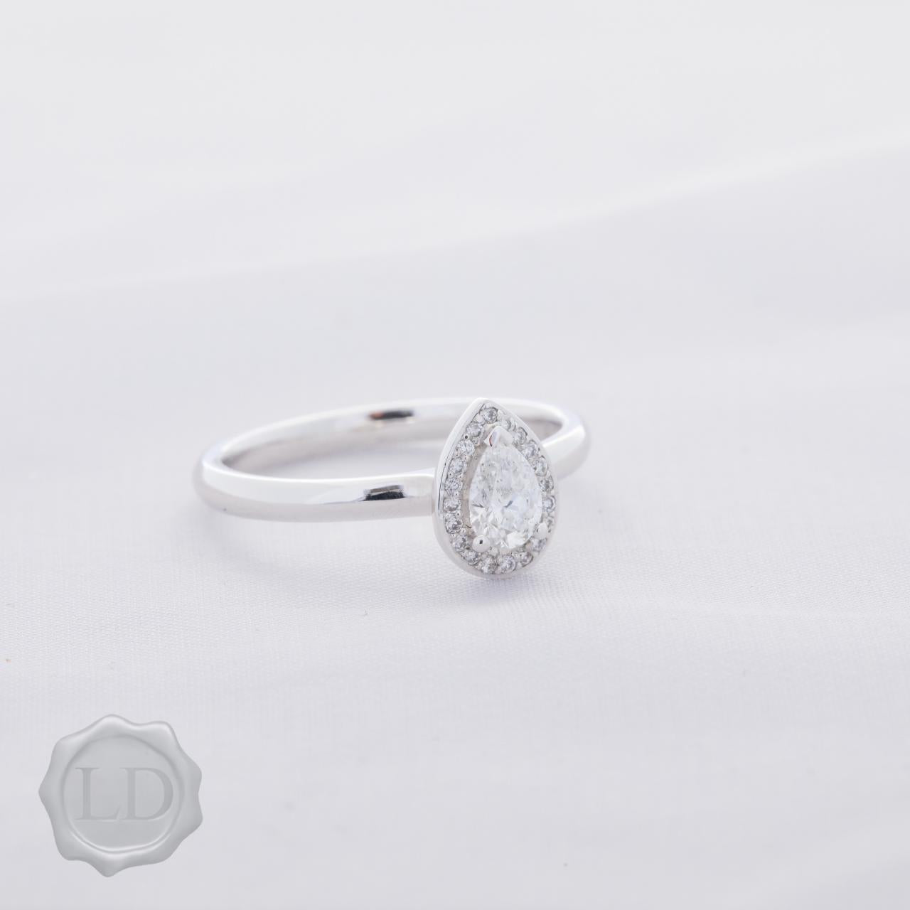 Pear cut halo engagement ring in 18ct white gold