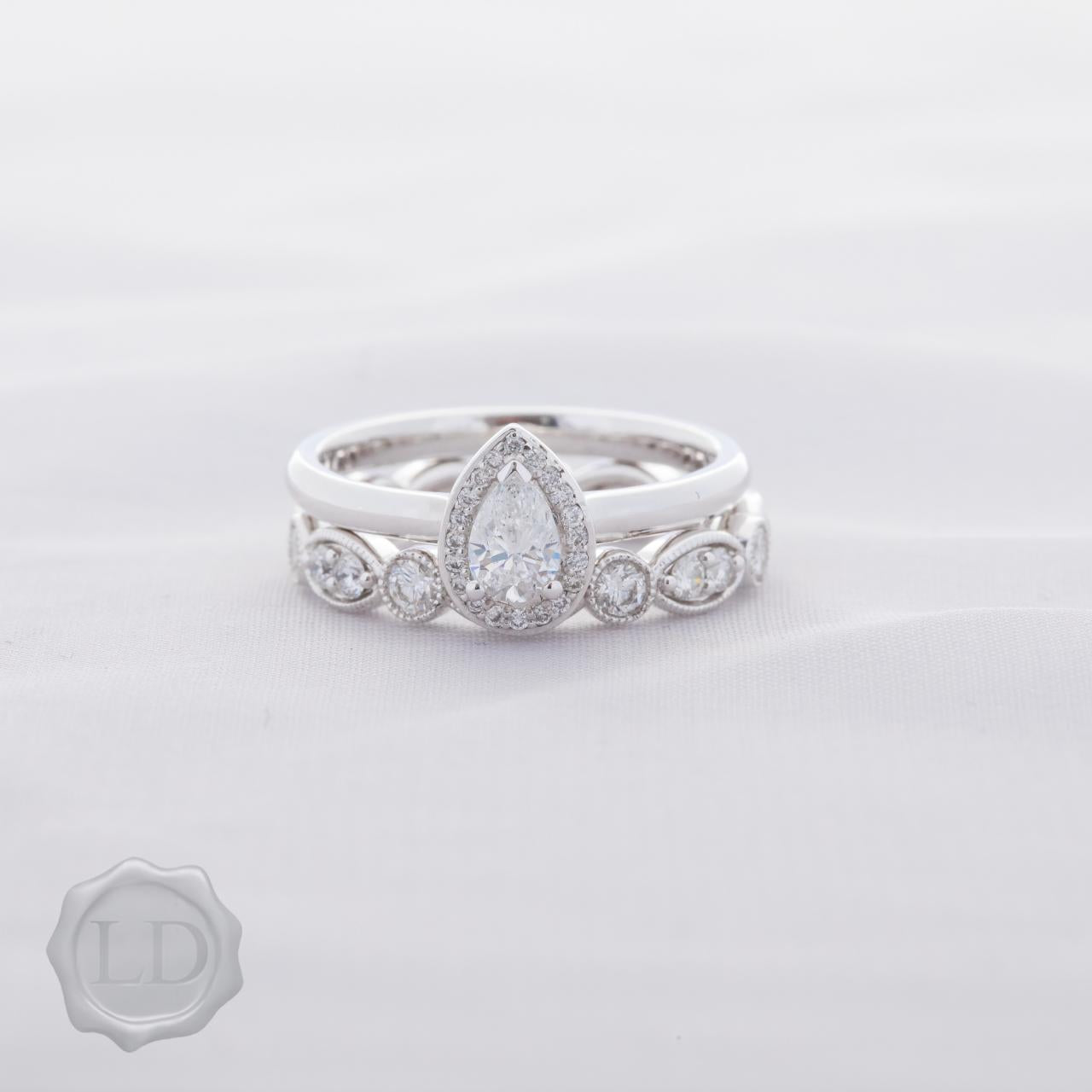 Pear cut halo engagement ring in 18ct white gold