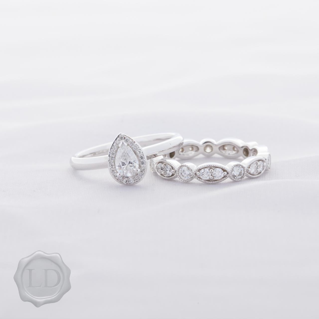 Pear cut halo engagement ring in 18ct white gold