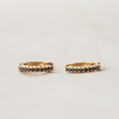 Dainty black diamond huggies, yellow gold