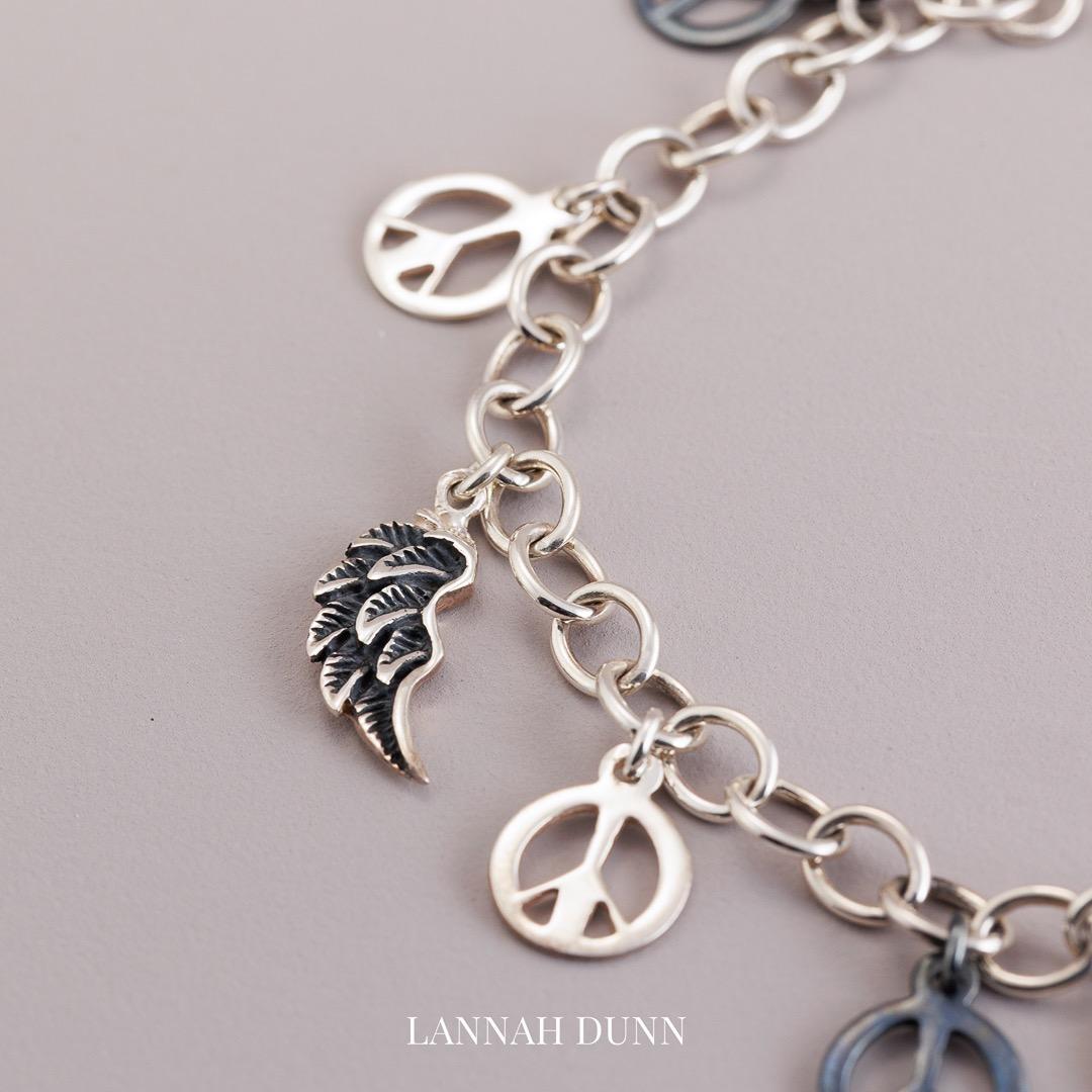 Sterling silver peace, dove, angel wing multi charm bracelet