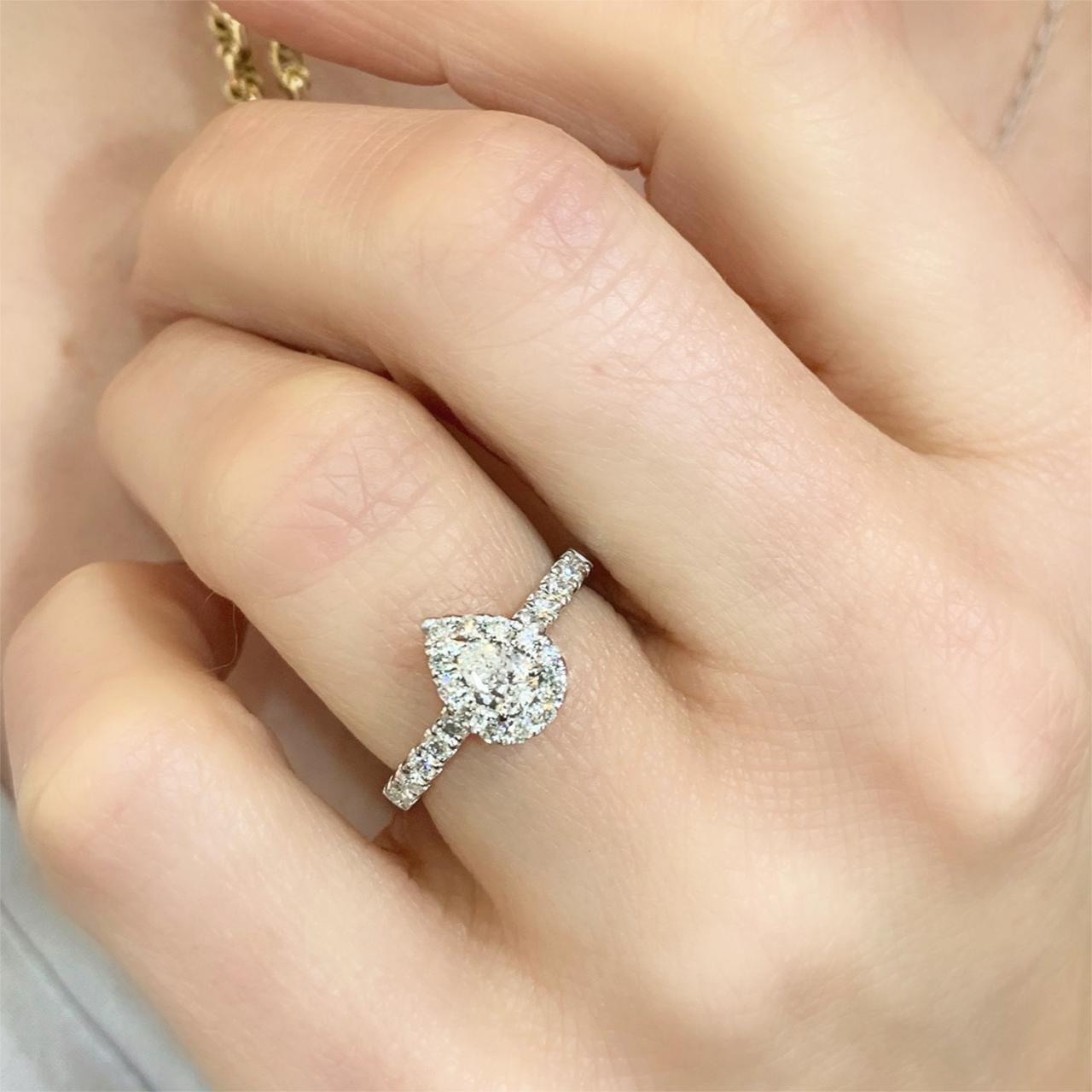 Pear-cut halo with diamond band