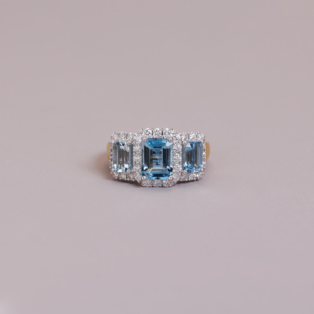 The LD triple Emerald cut aquamarine and diamond cluster, yellow gold