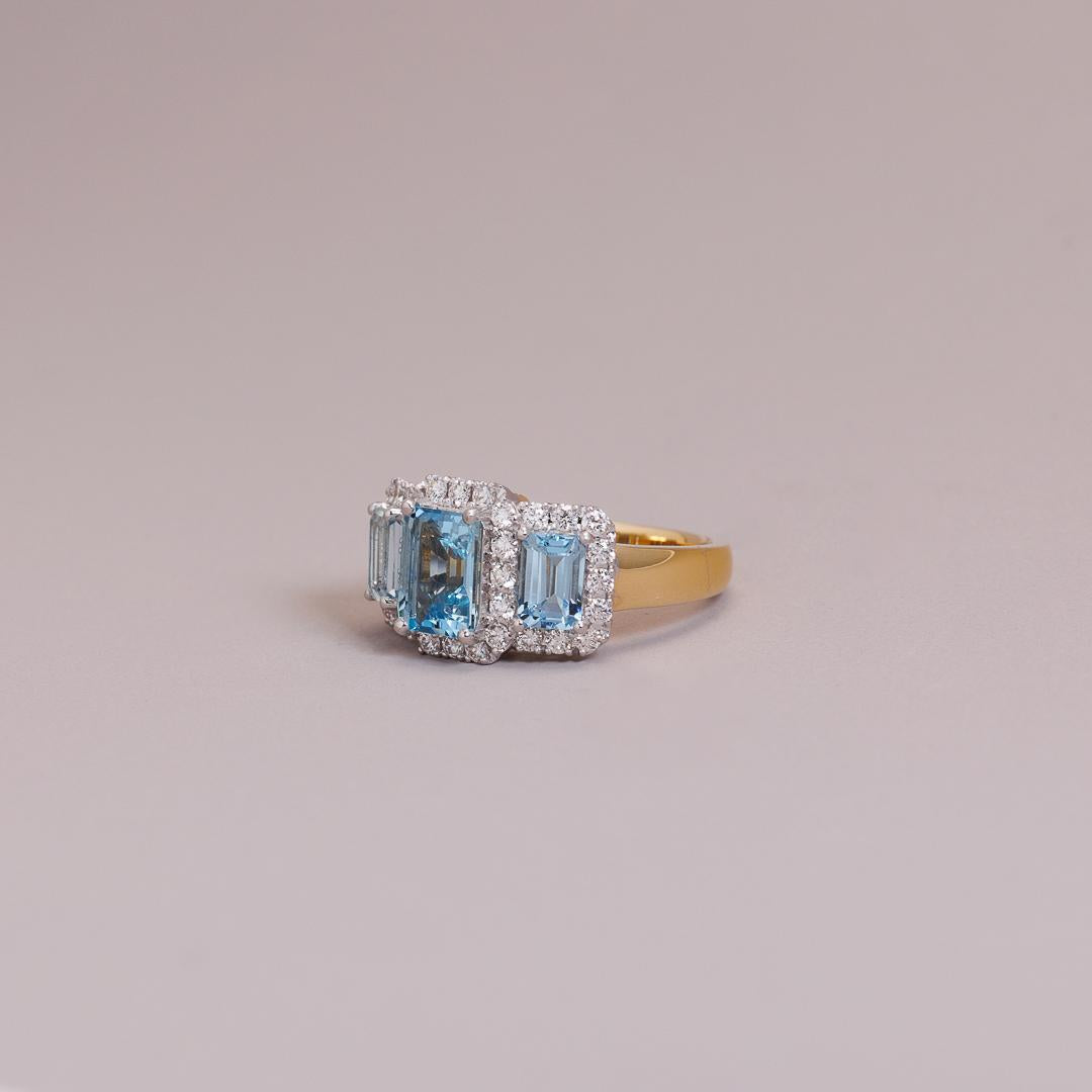 The LD triple Emerald cut aquamarine and diamond cluster, yellow gold