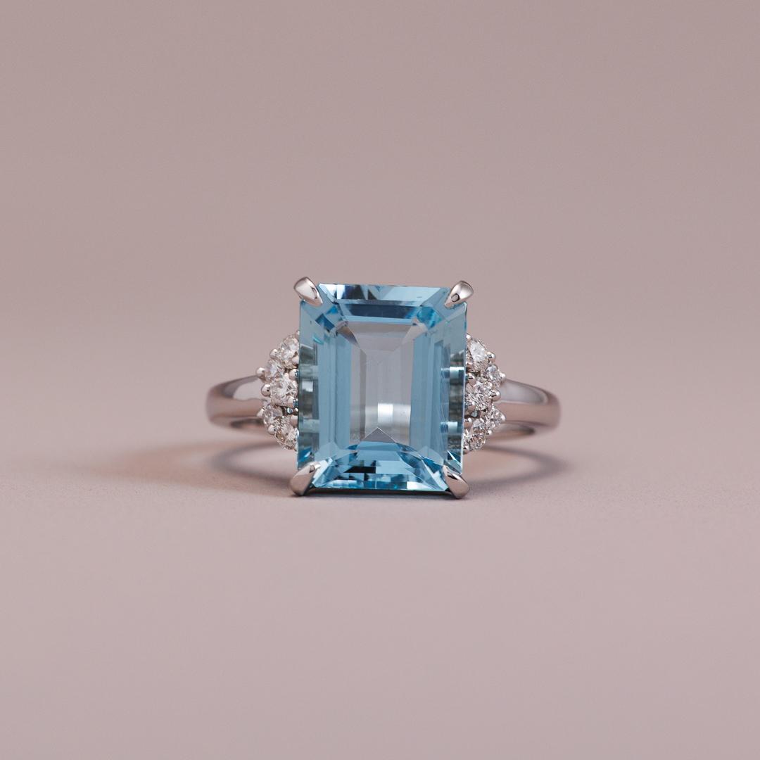 Emerald-cut aquamarine gemstone engagement ring with white diamonds in white gold