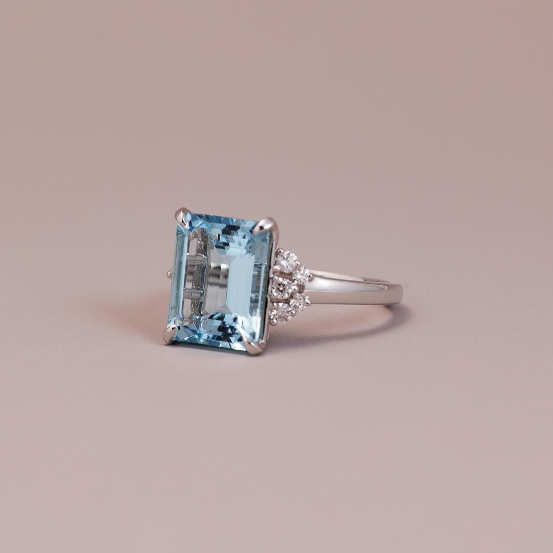 Emerald-cut aquamarine gemstone engagement ring with white diamonds in white gold