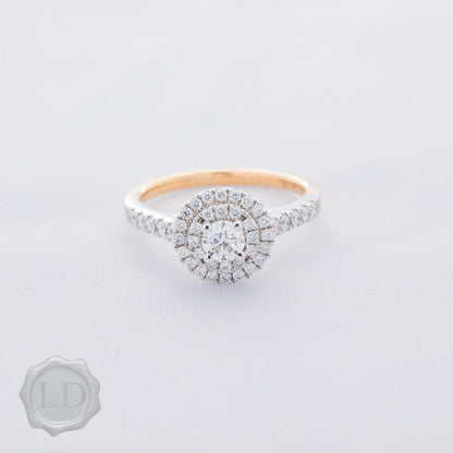 Rose gold engagement ring with double halo and round brilliant cut shoulders